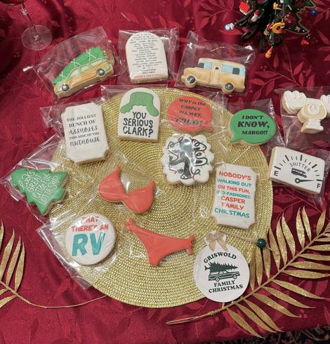 Photo of a spread of cookies each individually made in different shapes. The car, the RV, the bathing suit. And some of the funnier lines. Amazing