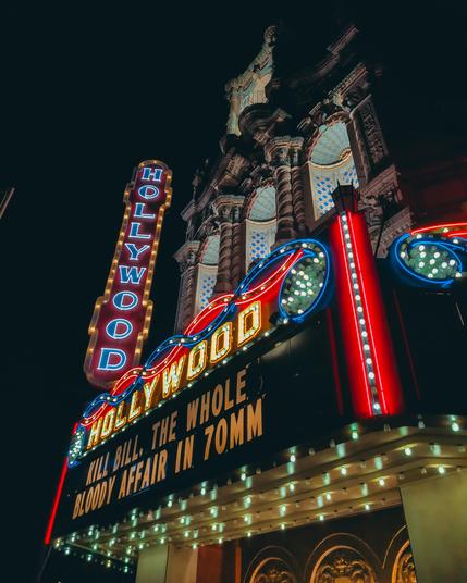 The Hollywood Theater in Portland, Oregon at night lit up with "KILL BILL, THE WHOLE BLOODY AFFAIR IN 70MM" on the marquee