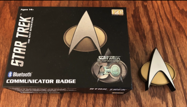 A picture of the box and the actual toy which is a Bluetooth communication badge from Star Trek the next generation. 