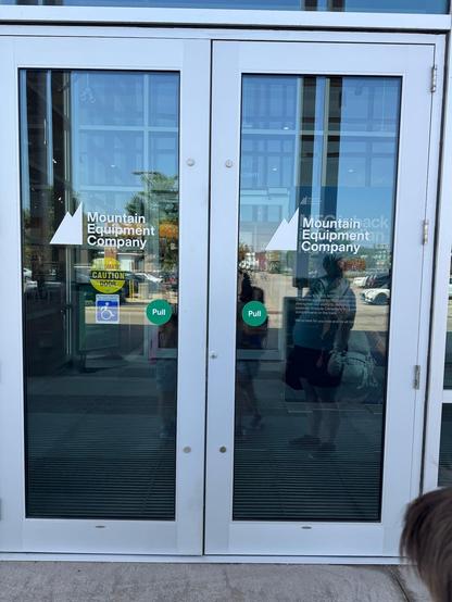 Picture of a commercial double door. There are circular 