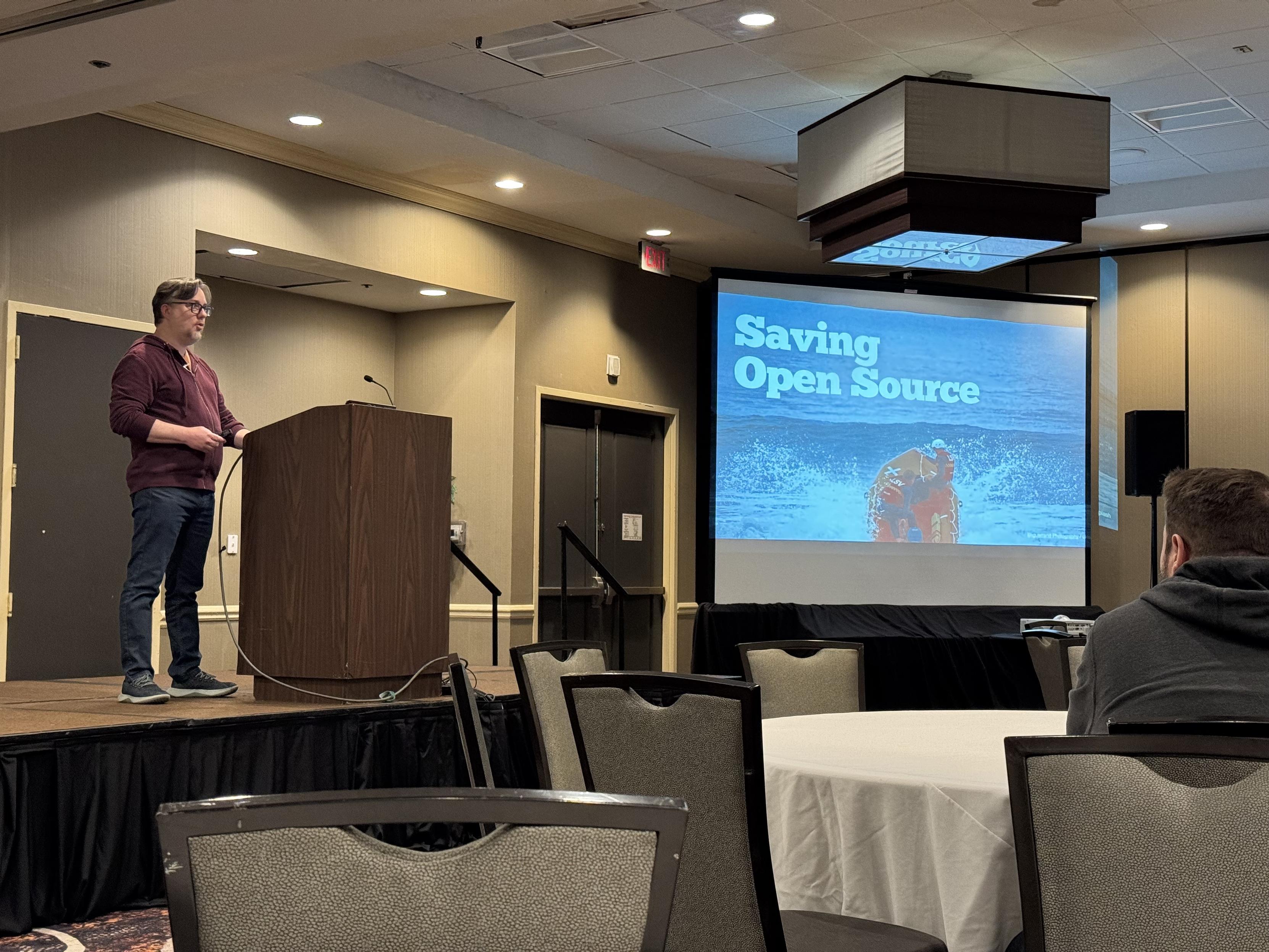Ben Ramsey on stage presenting his closing keynote  of Longhorn PHP 2025 about Saving Open Source.