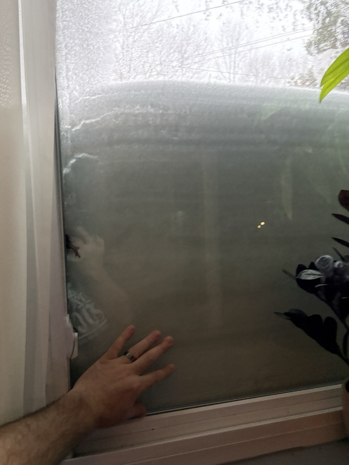 A window covered with snow about 3 feet deep