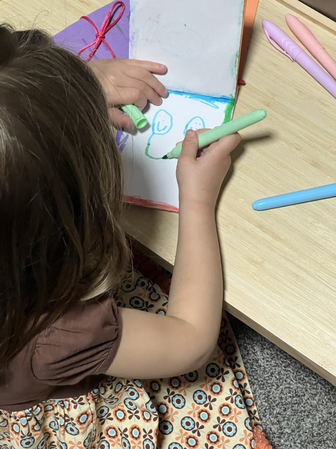 Young girl drawing in her new custom bound sketchbook