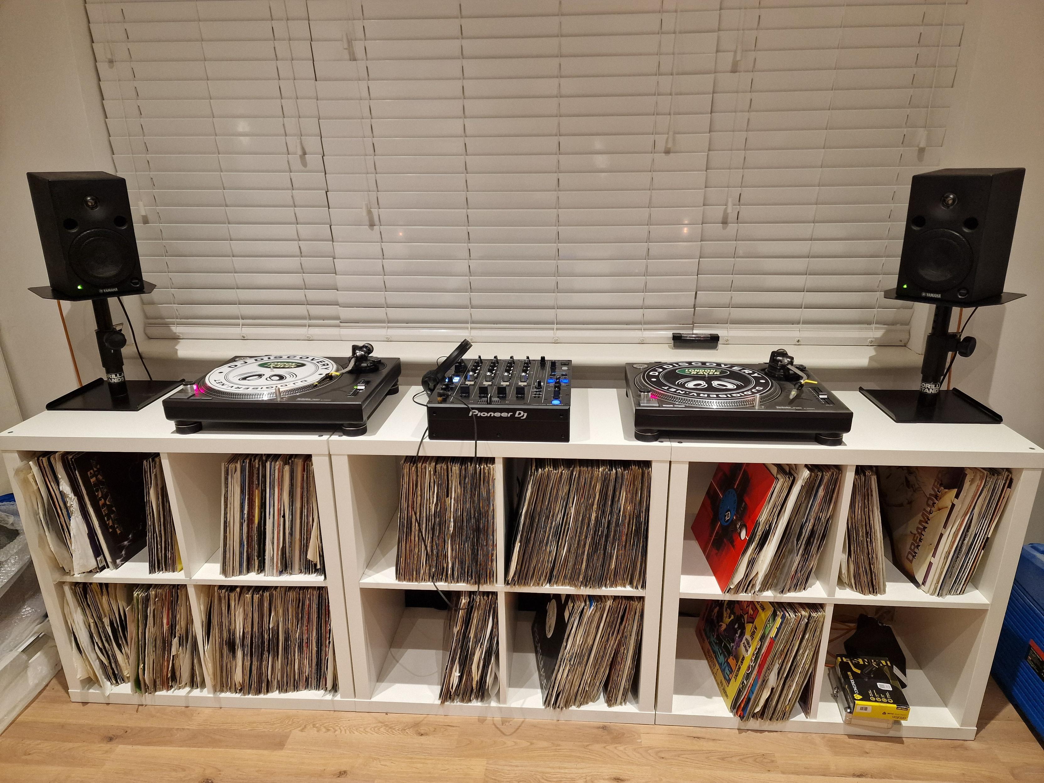 DJ setup including Technic 1210 turntables, PioneerDJ 750MK2 mixer and a bunch of vinyl records